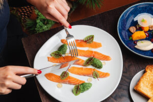 person eating modern styled salmon dish