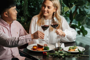 couple at modern british rooftop restaurant and bar drinking red wine