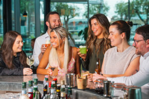 people drinking cocktails at rooftop bar and restaurant in leeds city centre